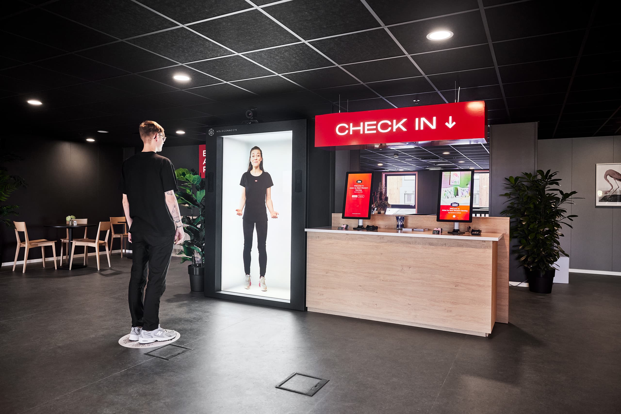 A Holobox check-in hostess welcoming hotel guests.