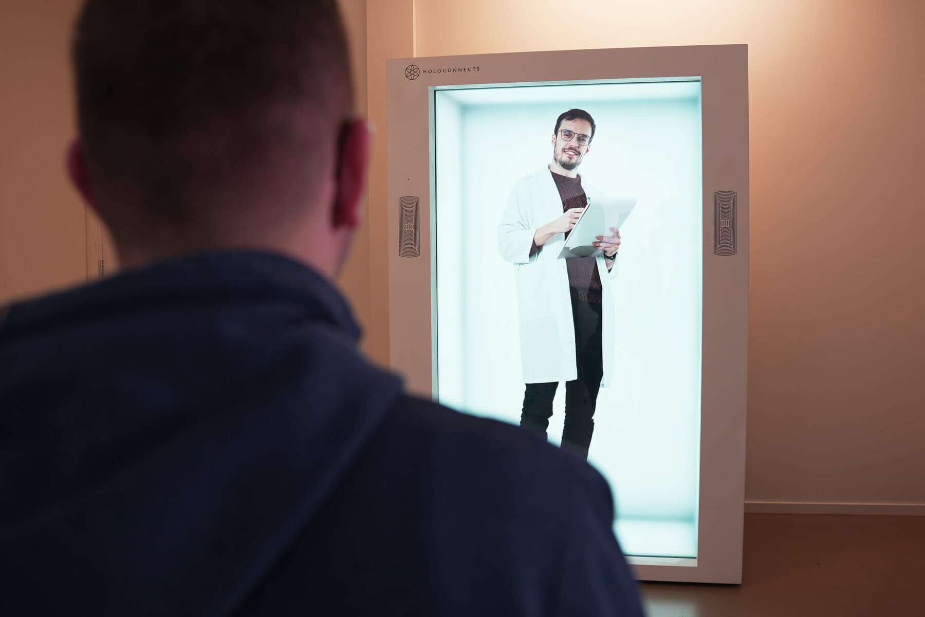 A clinician consulting a patient as a life size hologram.