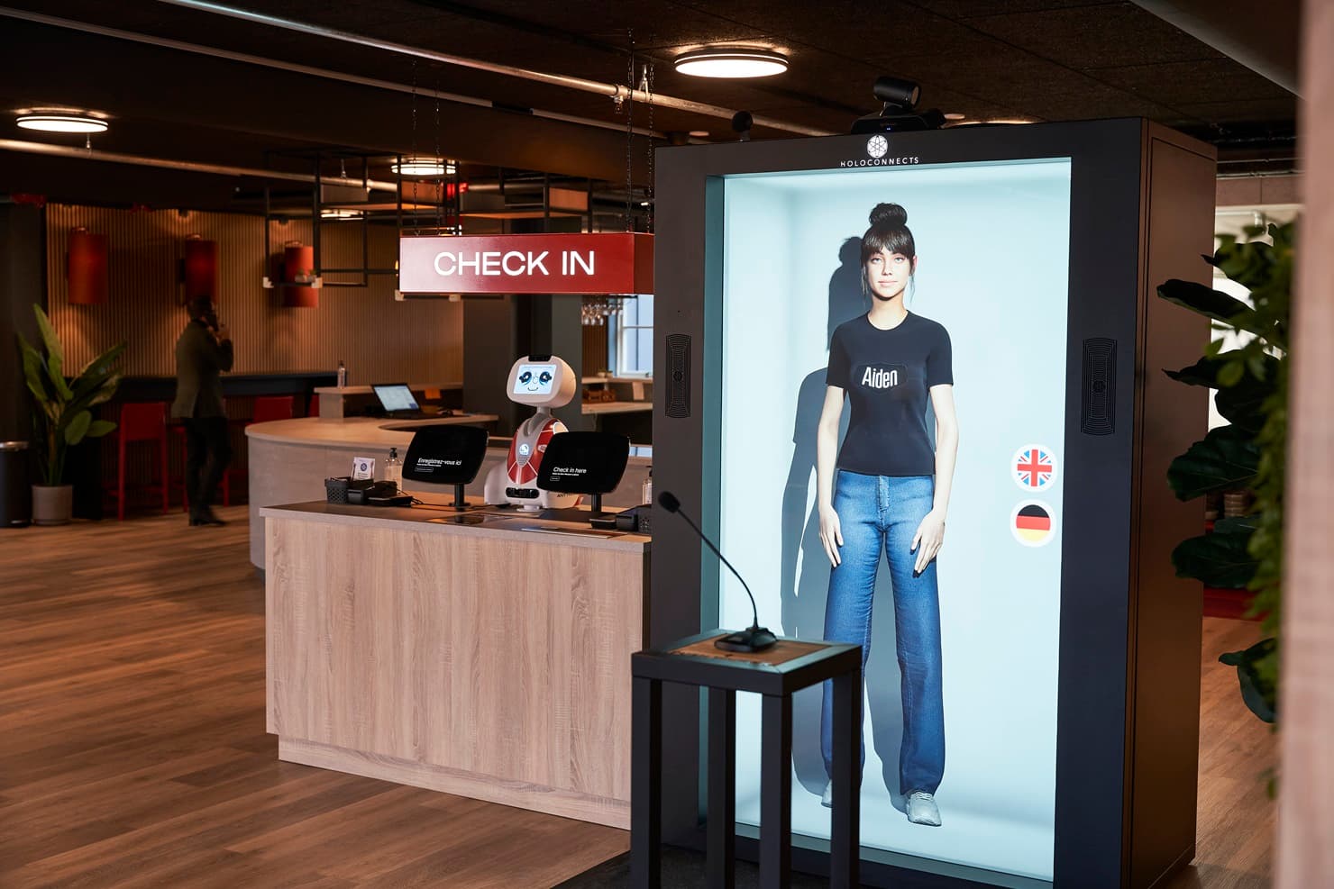 AI-powered holographic check-in avatar inside a Holobox at Aiden by Best Western.