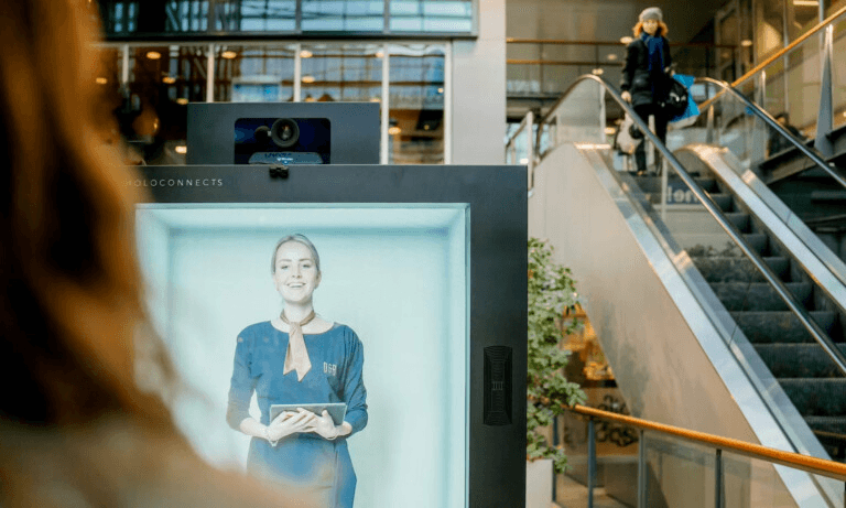 Holobox-powered hospitality welcome — a holographic concierge greeting hotel guests.