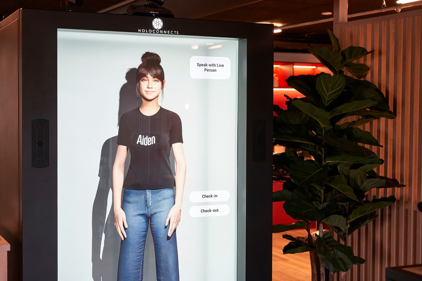 An AI check-in host on a Holobox, with a button to speak with a live person